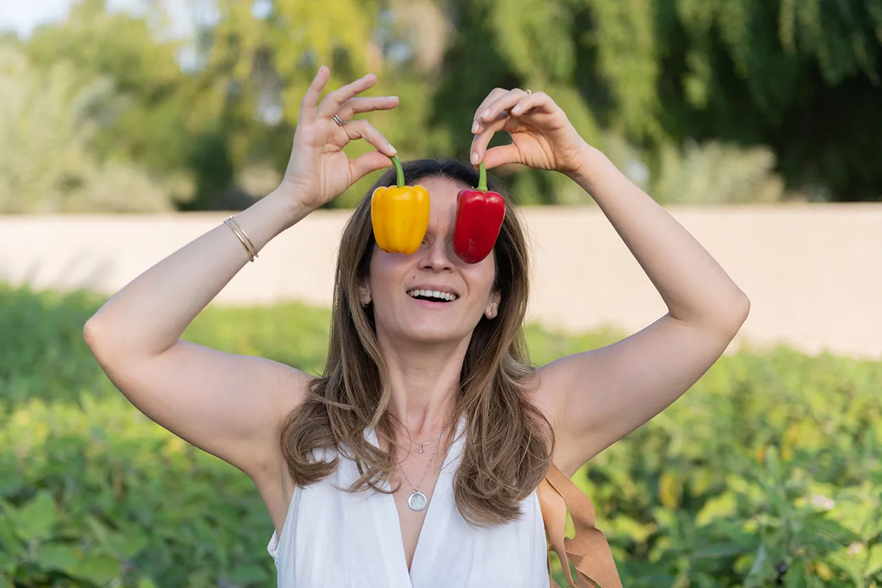 Laughing while holding peppers